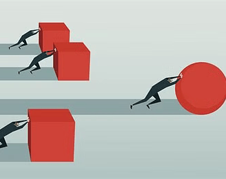 a man is pushing a giant red object in a line