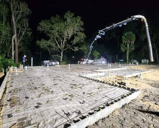 Pumping concrete on a night-time construction job with a boom pump.