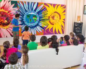 Artist Yous presenting this large triptique oil painting to the gallery visitors