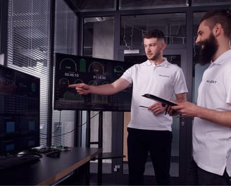 Willbert and DC Charging two men standing in front of a tv screen