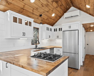 Modern kitchen in tiny home on wheels with wood accents