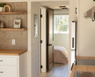 Cozy bedroom view inside bright tiny home on wheels