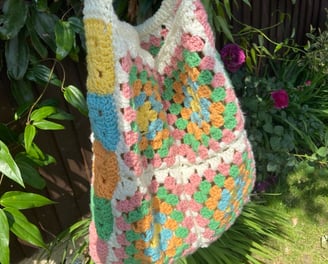 Handmade crochet tote bag with pastel colours pink, green, orange, blue, yellow and white 