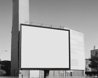 A yellow sign with bold black text in German promoting an agency located on a street. The background shows part of an urban setting with tables and chairs on a sidewalk.