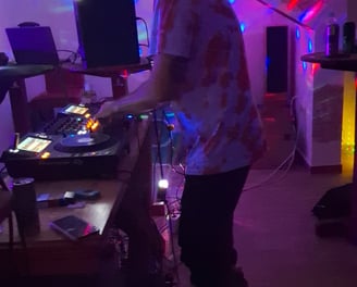 a man in a room with a dj booth