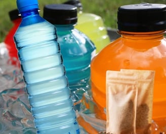 a variety of different colored bottles of water and energy drinks