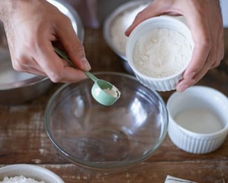 a person is holding a spoon and spoon in their hands