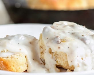 a plate sausage Biscuits and gravy