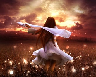 a woman in a white dress standing in a field
