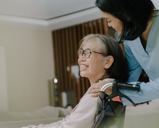 woman in wheelchair, caring for elderly