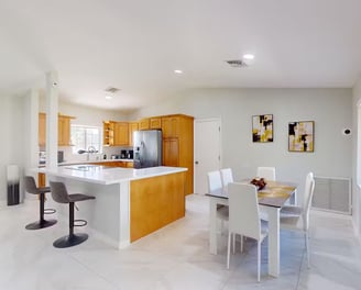 a kitchen with a table and chairs and a table