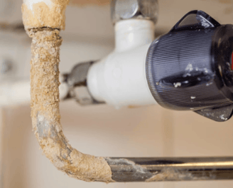 hard water plumbing damage on a boiler pipe