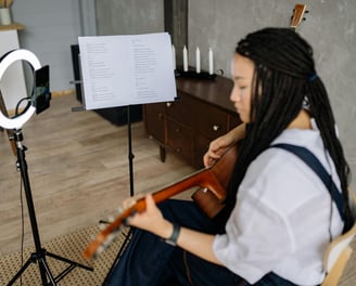 Acoustic guitar and sheet music setup for a guitar lesson