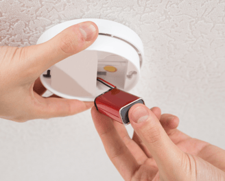 smoke alarm battery being replaced