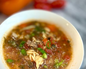 a bowl of soup with noodles and vegetables