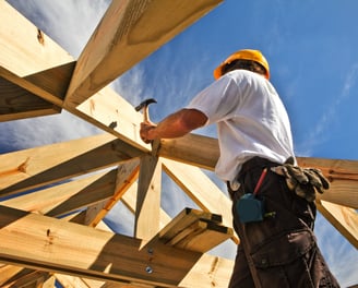 a construction worker is working on a roof