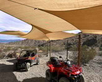 two atvs parked in a desert area