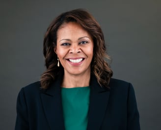 a woman in a green top and a black jacket
