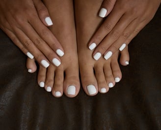 a woman's feet with white nails and white nails
