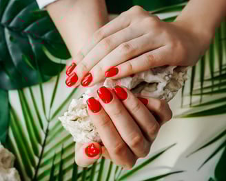 a woman's hands with red nails and red nails