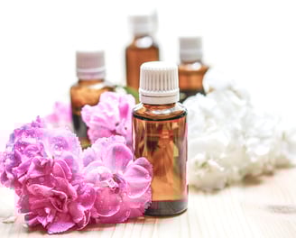 a bunch of flowers and bottles of essential oils