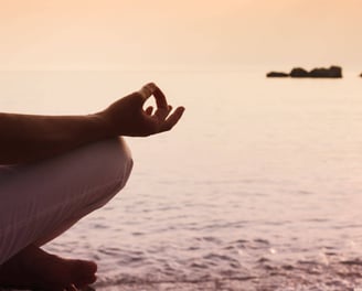 Meditation in a serene environment by the water - Holistic Health Company