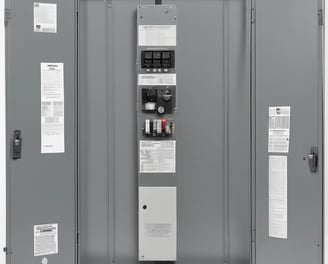 A black and white image of an electrical junction box mounted on a vertical pole. The box is labeled with the code '2DJ030305' and has several wires and cables connected beneath it. The background is blurred, with indistinct structures visible.