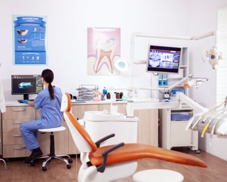 a woman in a chair in a dental room