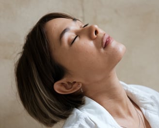 a woman doing face yoga