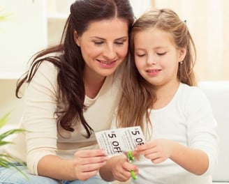 woman clipping coupons