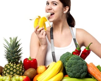 woman eating colorful fruits