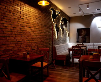 a restaurant with a brick wall and a couch