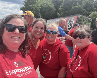 4 women in red "Empowered Educators" tshirts on