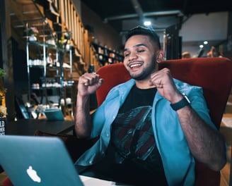 a man sitting in a chair with a laptop