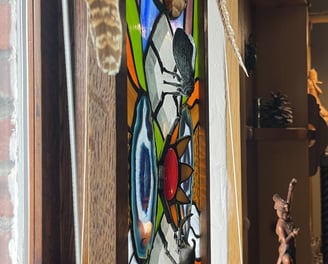 brass insects added to stained glass art