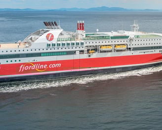 a large boat with a red and white boat in the water