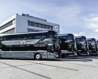 a group of buses parked in front of a building
