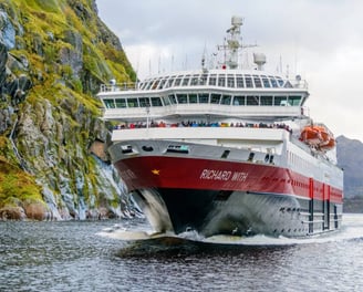 a large boat is coming down the river
