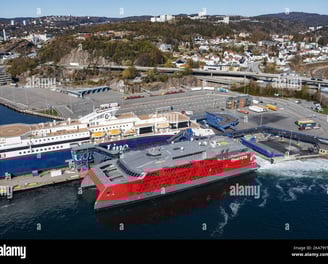 a large ship in the water with a large ship in the background