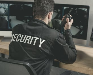 a security officer in uniform with a cell phone