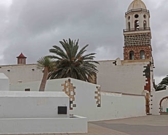 a clock tower with a clock tower in the background