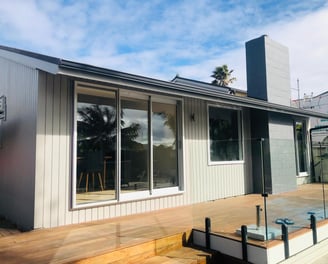 a house with a deck and a deck with a view of the ocean