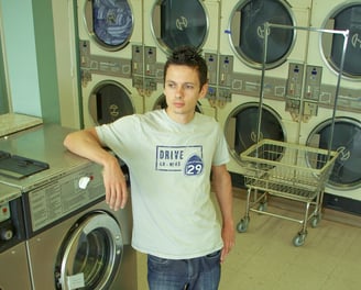 a man standing in front of a laundry machine