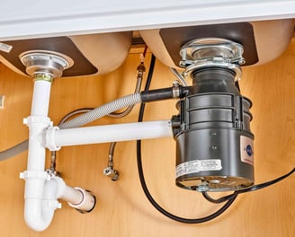 an undersink view of a garbage disposal