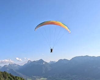 a person parasailing over a mountain