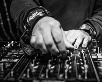 a dj mixing music in a dj booth