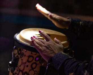 a person playing a drum drum in a room