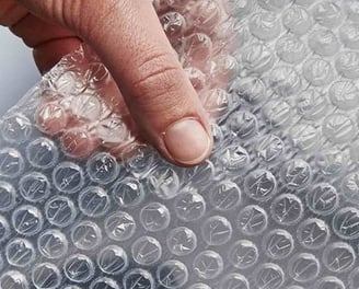 a person holding a piece of bubble bubble wrap