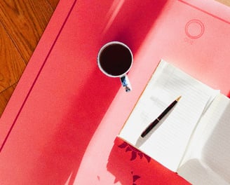 Cup of coffee and notebook, showing blogging and ghost blog writing services available.