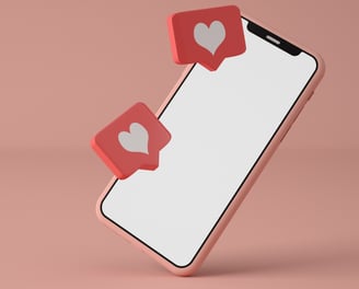 Image of a phone with like heart icons representing social media and design. Pink phone